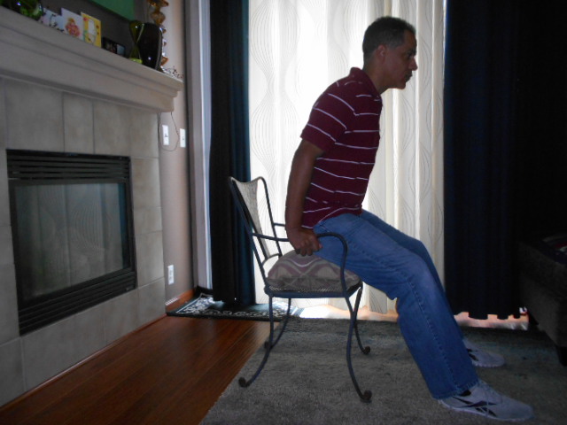 elderly people sitting by fireplace